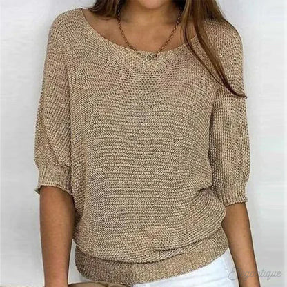 Image of a woman wearing an elegant relaxed fit sweater, featuring a chic design perfect for casual and stylish occasions.