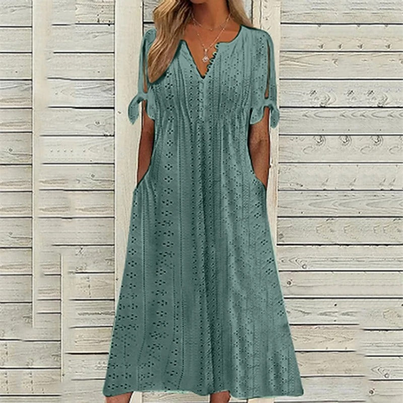 A stylish midi dress featuring intricate eyelet detailing, open sleeves with tie accents, a flattering V-neckline, and a relaxed fit, perfect for casual or semi-formal occasions.