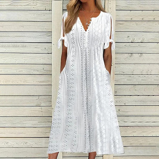 A stylish midi dress featuring intricate eyelet detailing, open sleeves with tie accents, a flattering V-neckline, and a relaxed fit, perfect for casual or semi-formal occasions.