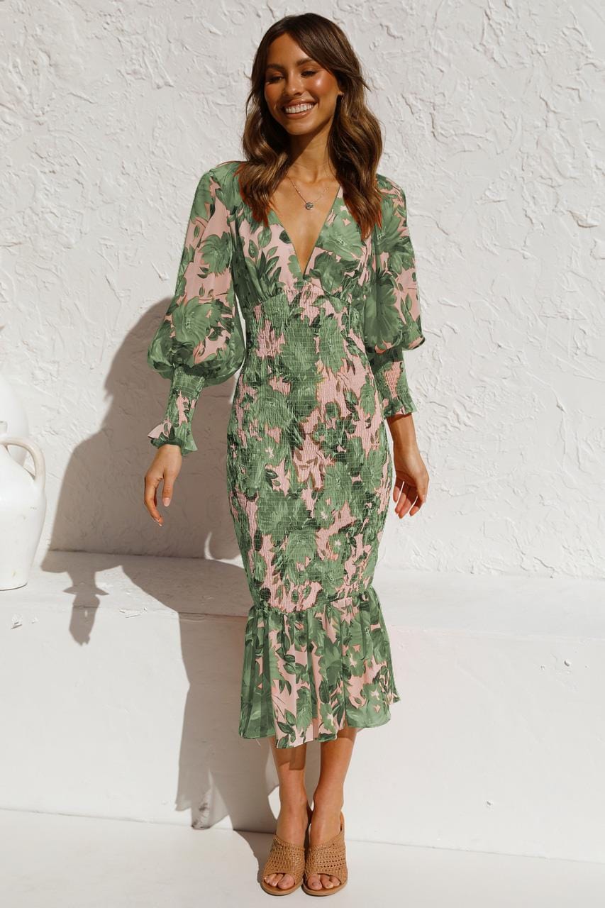 Model wearing Emilia, a women's floral midi dress with elegant ruffled sleeves, a fitted waist, and a flowing hemline, perfect for a chic and stylish look.
